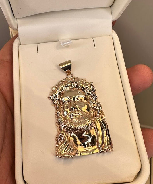 Dije de cabeza de Cristo en oro en su estuche