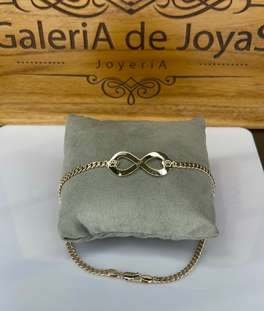 Pulsera con símbolo infinito y patitas en oro