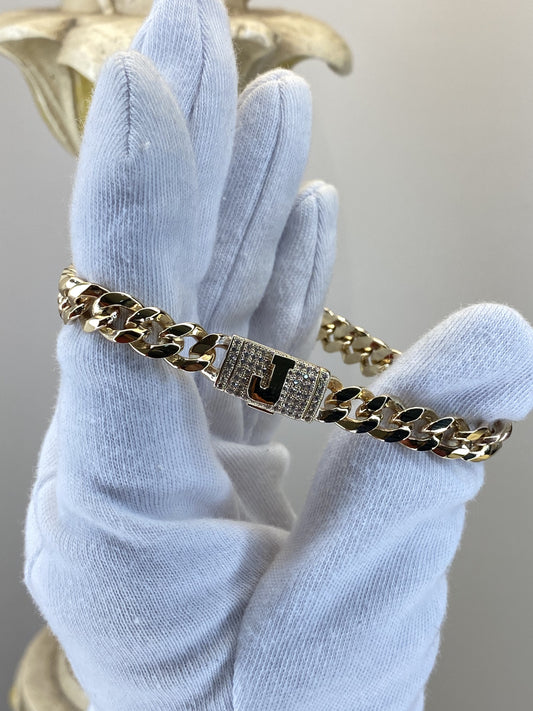 Pulso cubano con inicial J en pavé de zirconias en oro